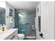 Bright bathroom featuring a glass shower door and a white sink with black fixtures at 14130 Rosemary Ln # 1202, Largo, FL 33774