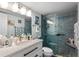 Bright bathroom featuring a glass shower door and a white sink with black fixtures at 14130 Rosemary Ln # 1202, Largo, FL 33774