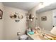 Cozy bathroom featuring unique wall art and a light peach-colored sink at 14130 Rosemary Ln # 1202, Largo, FL 33774