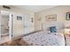 Bright bedroom featuring coastal themed decor and attached bathroom at 14130 Rosemary Ln # 1202, Largo, FL 33774