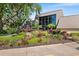 Clubhouse entrance with vibrant landscaping and modern architectural details at 14130 Rosemary Ln # 1202, Largo, FL 33774