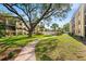 Lush courtyard with mature trees, manicured landscaping, and inviting sidewalks at 14130 Rosemary Ln # 1202, Largo, FL 33774