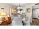 Light dining area with glass table and access to kitchen area at 14130 Rosemary Ln # 1202, Largo, FL 33774