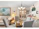 Bright dining area featuring a glass table with grey chairs and a display cabinet at 14130 Rosemary Ln # 1202, Largo, FL 33774
