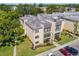 Well maintained exterior of a condominium building showcasing landscaping and parking at 14130 Rosemary Ln # 1202, Largo, FL 33774