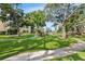 Landscaped grounds showcasing lush greenery and a serene walkway near the condominiums at 14130 Rosemary Ln # 1202, Largo, FL 33774
