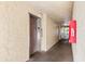 Clean and well-lit condo hallway leading to an elevator at 14130 Rosemary Ln # 1202, Largo, FL 33774