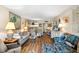 Bright living room featuring view into kitchen and coastal decor at 14130 Rosemary Ln # 1202, Largo, FL 33774