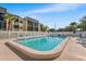 Inviting outdoor pool surrounded by lounge chairs and meticulously maintained landscaping at 14130 Rosemary Ln # 1202, Largo, FL 33774