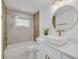 Beautiful bathroom featuring a modern vanity, decorative mirror, and stylish tile with shower and bath at 1717 Thames St, Clearwater, FL 33755