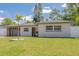 Beautifully landscaped single-story home with brick and plank siding and a well-maintained lawn at 1717 Thames St, Clearwater, FL 33755