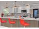 Elegant kitchen featuring a quartz countertop, a breakfast bar with seating, and modern light fixtures at 1717 Thames St, Clearwater, FL 33755