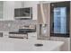 Modern kitchen with stainless steel appliances, sleek white cabinets, and a gray backsplash, offering style and functionality at 1717 Thames St, Clearwater, FL 33755