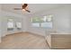 Bright living room with light wood flooring, ceiling fan, french doors, and a comfortable white sofa at 1717 Thames St, Clearwater, FL 33755