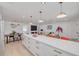 Open concept living area with a white quartz kitchen island, dining table and comfortable seating space at 1717 Thames St, Clearwater, FL 33755