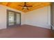 Enclosed patio showcasing a wooden ceiling, ceiling fan, and gray trim at 1717 Thames St, Clearwater, FL 33755