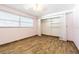 Bedroom with wood look floors, a ceiling fan, two windows, and open closet at 1760 Sharondale Dr, Clearwater, FL 33755