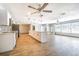 Spacious kitchen and living area with wood-look floors and modern stainless steel appliances at 1760 Sharondale Dr, Clearwater, FL 33755