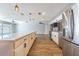 Modern kitchen featuring stainless steel appliances, a large island with quartz countertops, and wood-look flooring at 1760 Sharondale Dr, Clearwater, FL 33755