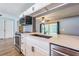 Close-up view of a modern kitchen with stainless steel appliances, subway tile backsplash and quartz countertops at 1760 Sharondale Dr, Clearwater, FL 33755