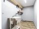 Practical laundry room with utility sink and shelving for storage at 1760 Sharondale Dr, Clearwater, FL 33755