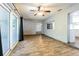 Spacious living room with lots of natural light, wood-look flooring, and open to the kitchen at 1760 Sharondale Dr, Clearwater, FL 33755