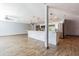 Open-concept living space featuring wood-look floors, modern lighting, and seamless flow to the kitchen at 1760 Sharondale Dr, Clearwater, FL 33755
