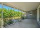 Covered patio with screen enclosure offering views of the lush backyard and landscaping at 1760 Sharondale Dr, Clearwater, FL 33755