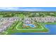 Aerial view showcases a community pool, clubhouse, sidewalks, surrounding homes and lake nearby at 20659 Drake Elm Dr, Land O Lakes, FL 34638