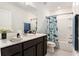 Cozy bathroom with a single sink vanity, a tub/shower combo, and charming decor at 20659 Drake Elm Dr, Land O Lakes, FL 34638