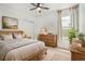Serene bedroom with a rustic wooden bed, soft natural light, and neutral decor at 20659 Drake Elm Dr, Land O Lakes, FL 34638