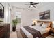 Bedroom with a wooden bed frame, ceiling fan, natural light, and modern decor at 20659 Drake Elm Dr, Land O Lakes, FL 34638
