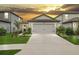Charming single-story home featuring a two-car garage and professionally landscaped front yard at 20659 Drake Elm Dr, Land O Lakes, FL 34638