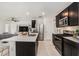 Beautiful kitchen featuring an island with quartz countertops, stainless steel appliances, and dark wood cabinets at 20659 Drake Elm Dr, Land O Lakes, FL 34638
