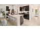 Modern kitchen with a quartz countertop island, stainless steel appliances, and dark wood cabinetry at 20659 Drake Elm Dr, Land O Lakes, FL 34638
