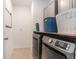 Well-lit laundry room with modern washer and dryer, and upper cabinets for ample storage at 20659 Drake Elm Dr, Land O Lakes, FL 34638