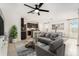 Open-concept living area with a comfortable sofa, modern decor, and bright, airy ambiance at 20659 Drake Elm Dr, Land O Lakes, FL 34638