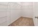 Empty walk-in closet ready for storage with shelving and carpeted floor at 20659 Drake Elm Dr, Land O Lakes, FL 34638