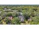 Scenic aerial view of the home with a private pool and lush, tree-lined surroundings at 213 Sheffield E Cir, Palm Harbor, FL 34683