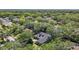 Expansive aerial view of a home nestled in a lush, green, tree-filled neighborhood at 213 Sheffield E Cir, Palm Harbor, FL 34683
