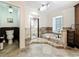 Bright bathroom with a shower, soaking tub, and step-up platform design at 213 Sheffield E Cir, Palm Harbor, FL 34683