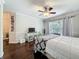 Bedroom with hardwood floors, ceiling fan, and sliding glass doors leading to a patio at 213 Sheffield E Cir, Palm Harbor, FL 34683