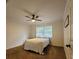 Cozy bedroom with neutral walls, ceiling fan, and window with natural light at 213 Sheffield E Cir, Palm Harbor, FL 34683