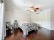 Bright bedroom with hardwood floors, closet, and a ceiling fan at 213 Sheffield E Cir, Palm Harbor, FL 34683