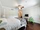 Comfortable bedroom with hardwood floors, ceiling fan, and ample closet space at 213 Sheffield E Cir, Palm Harbor, FL 34683