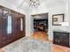 Entryway featuring double front doors and a view of an adjacent study with custom built-ins at 213 Sheffield E Cir, Palm Harbor, FL 34683