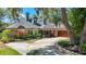 Beautiful home with brick accents, a lush front yard, and a two-car garage at 213 Sheffield E Cir, Palm Harbor, FL 34683