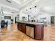 Open-concept kitchen island with stainless steel appliances, granite countertops, and tile flooring at 213 Sheffield E Cir, Palm Harbor, FL 34683