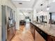 Bright kitchen with granite countertops, stainless steel appliances, tile flooring, and an eat-in area with natural light at 213 Sheffield E Cir, Palm Harbor, FL 34683
