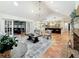 Open-concept living room with vaulted ceilings, chandelier, and easy access to the kitchen at 213 Sheffield E Cir, Palm Harbor, FL 34683